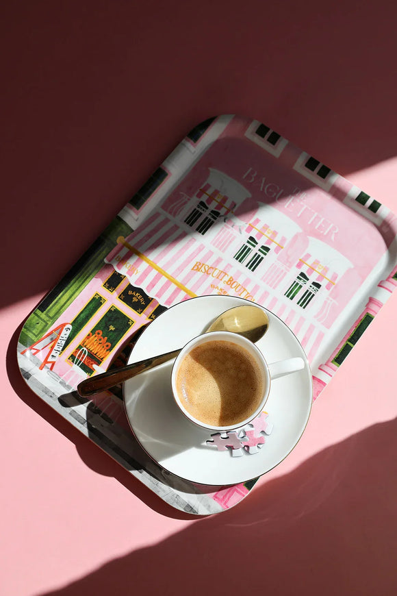 Top view of “The Baguetter” tray with coffee cup and golden spoon on a pink background.