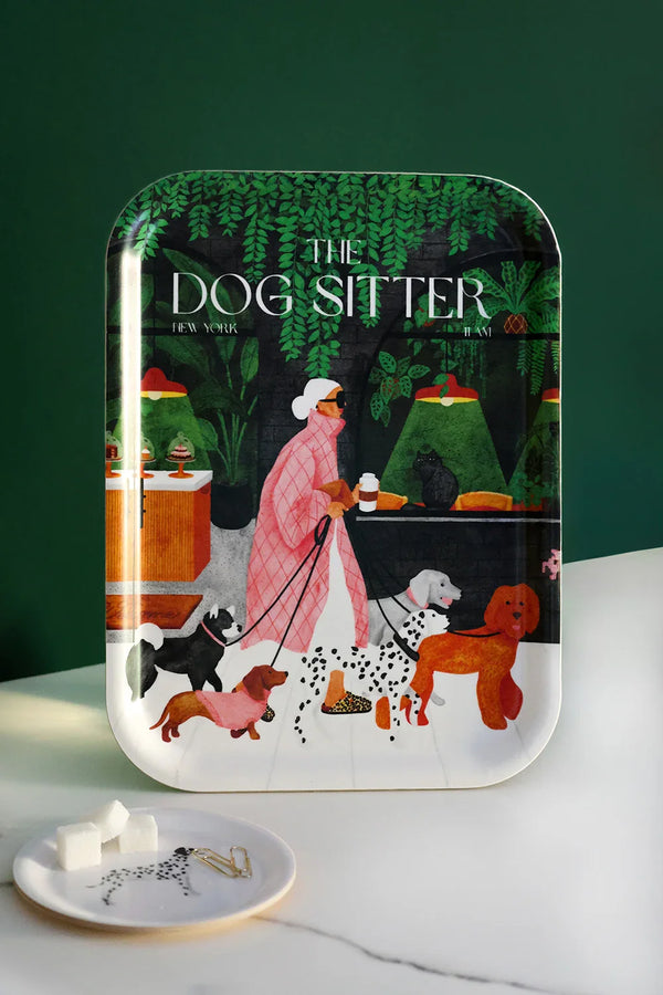 The Dog Sitter tray by All the Ways to Say featuring a stylish woman walking dogs through a lush green café scene, printed on eco-friendly birch wood with vibrant colors.
