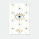 A radiant blue lucky eye enamel pin by All The Ways To Say with gold rays, displayed on a matching patterned backing card.