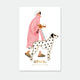 A white Dalmatian enamel pin by All The Ways To Say with black heart spots and gold outlines, displayed on an illustration of a woman in a pink coat.