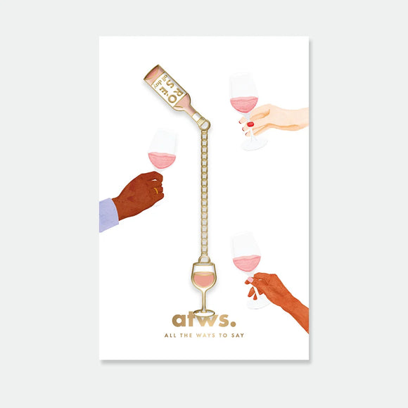 A gold enamel pin set featuring a rose wine bottle pouring into a glass connected by a chain, displayed on an illustration of hands toasting.