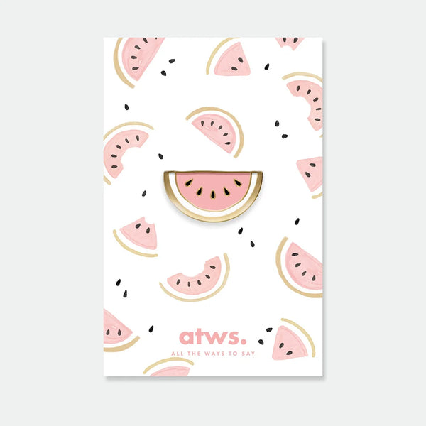 A pink watermelon slice enamel pin by All The Ways To Say with gold edges, displayed on a watercolor watermelon-themed backing card.