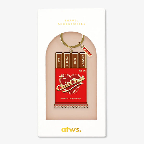 A witty gold enamel keychain by All The Ways To Say shaped like a red chocolate bar with the text "ChitChat" and "HAVE A BREAK HAVE A GOSSIP".
