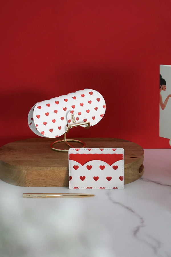 Red Hearts glasses case and card holder with red hearts design, displayed with matching notebooks and red lipstick.