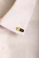 Duo Anti Idiots - Pins: the yellow and purple pill pin worn stylishly on a white shirt collar.
