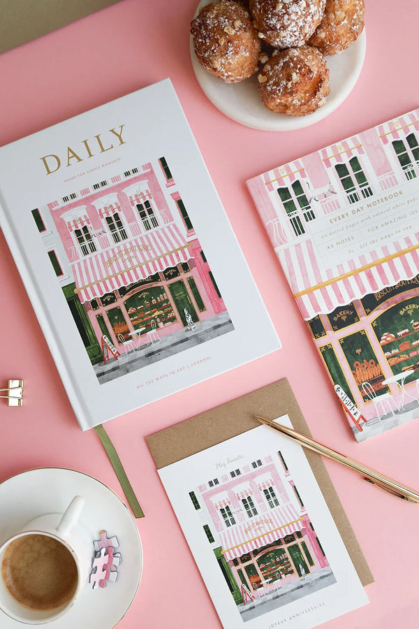 Daily planner and notebook from The Baguetter collection styled with pastries and pink accents