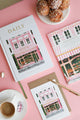 Daily planner and notebook from The Baguetter collection styled with pastries and pink accents