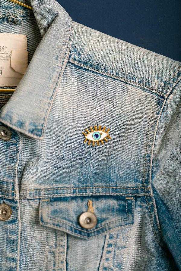 Close-up of the Blue Eye Enamel Pin with gold finish