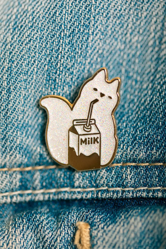 Detailed view of the Cat Milk Enamel Pin with glitter finish