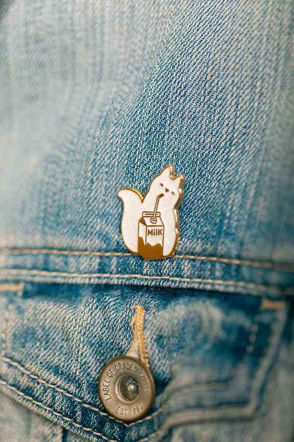 Side view of the Cat Milk Enamel Pin showing gold plating