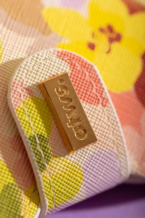 Spring Sweets Clip Case - Close-up of the engraved gold logo on the textured vegan leather.