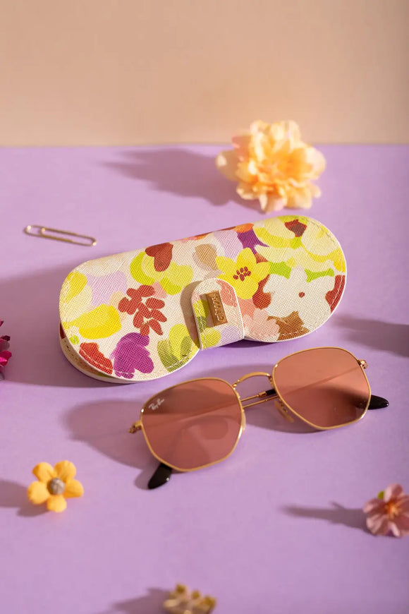 Spring Sweets Clip Case - Lifestyle view of the floral glasses case with sunglasses on a purple background.