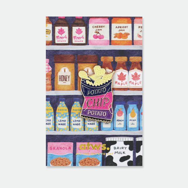 Enamel pin shaped like a bag of potato chips in navy blue and pink, text reading "Potato Chip Potato"