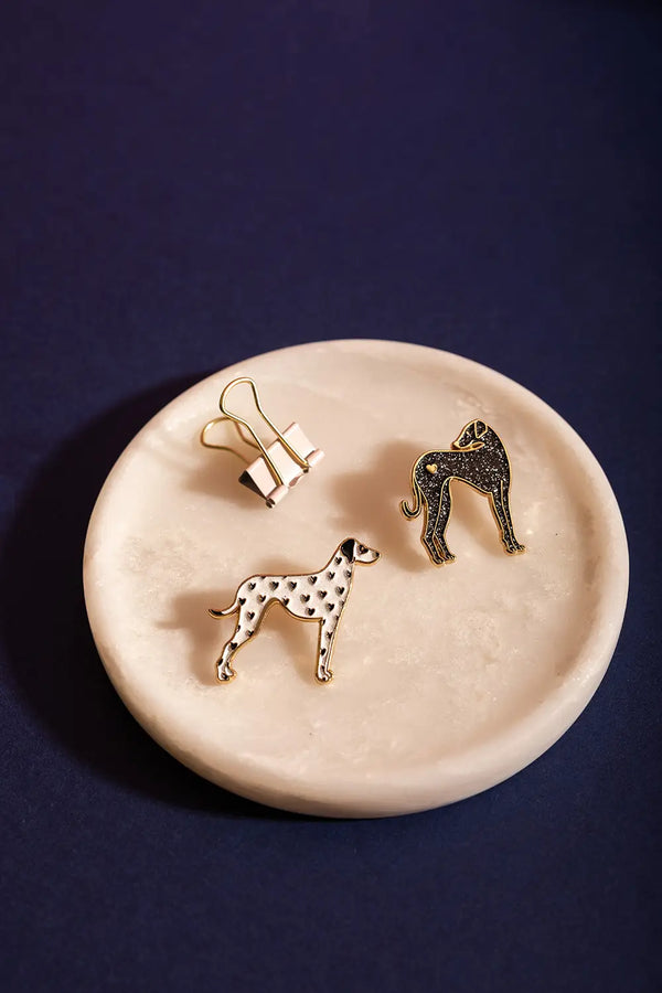 Dalmatian - Pins: A collection of dog-themed enamel pins presented on a marble tray.