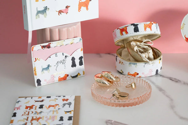 Close-up of Dogue card holder and jewelry box with colorful dog illustrations