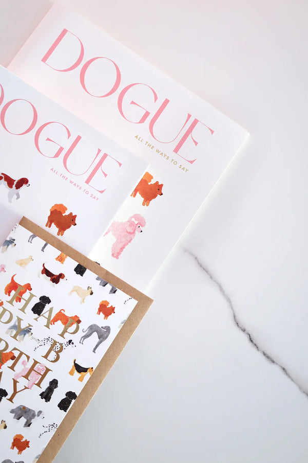 Dogue notebooks with dog illustrations and matching card on marble surface