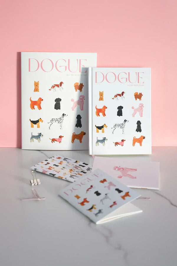 Dogue stationery and accessories styled on marble desk with pink background
