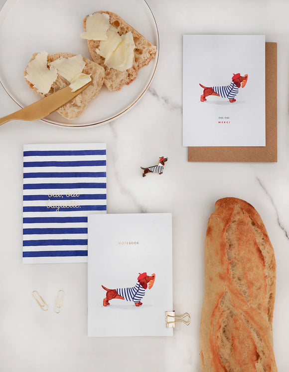 All The Ways To Say Frenchie stationery and enamel pin – dachshund in sailor outfit surrounded by baguette and notebooks