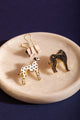 Greyhound - Pins: a black glittery greyhound pin paired with a dalmatian pin on a marble tray.