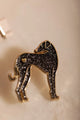 Greyhound - Pins: close-up of the black enamel greyhound pin featuring a tiny gold heart on its hip.