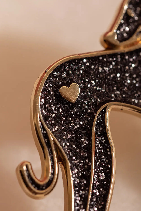 Greyhound - Pins: macro view of the high-quality black glitter texture and gold plating of the pin.
