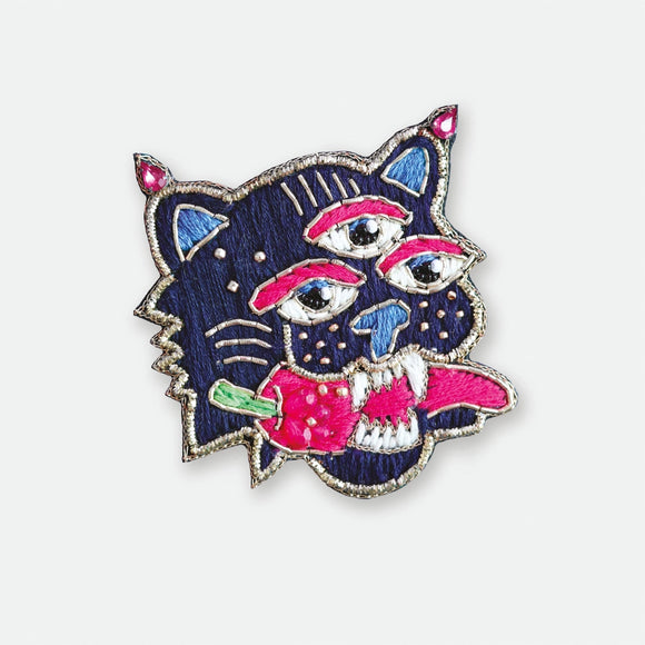 Hand-embroidered Mexican Tiger brooch with three eyes, vibrant pink details, and gold cannetille wire.