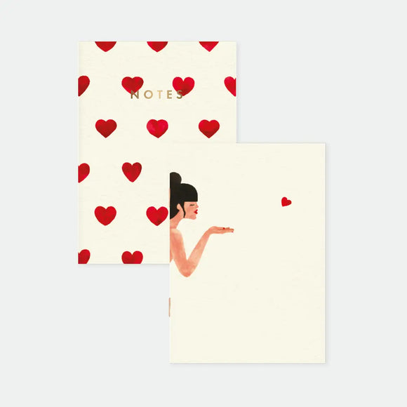 Bisou - Pocket Notebook A6 DUO: front view of the duo pack including a red heart pattern notebook and a blowing kiss illustration notebook.