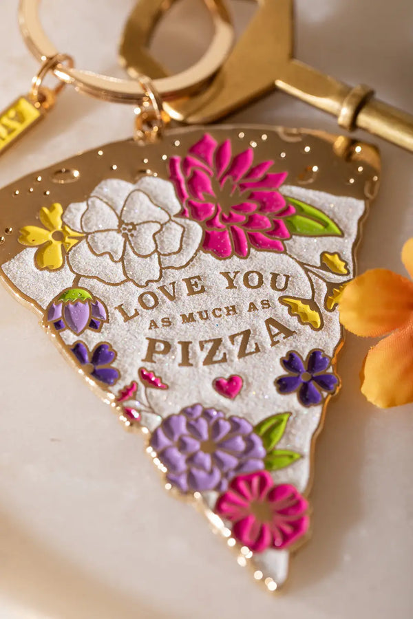 As much as pizza Keychain - Macro shot focusing on the golden engraving and vibrant colors.