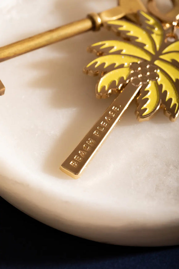 Beach please Keychain - Macro shot focusing on the "BEACH PLEASE" engraving on the side.