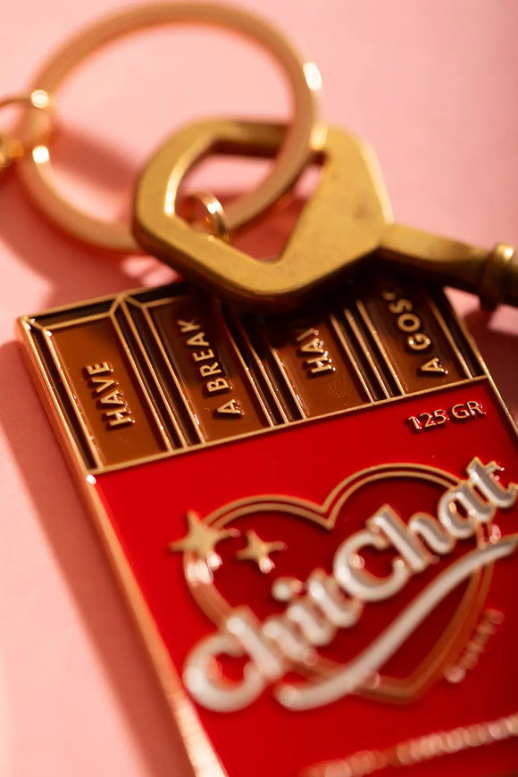 Chit chat Keychain - Close-up on the golden "Have a break" and "Have a gossip" engravings.