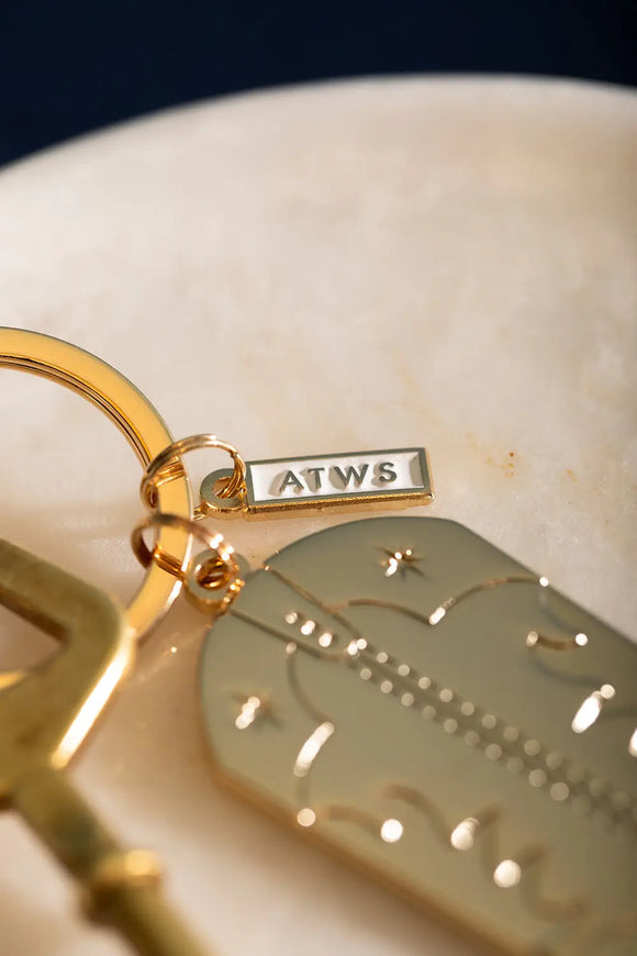 Cowboy Boot Keychain - Detail of the white and gold ATWS logo charm on the key ring.