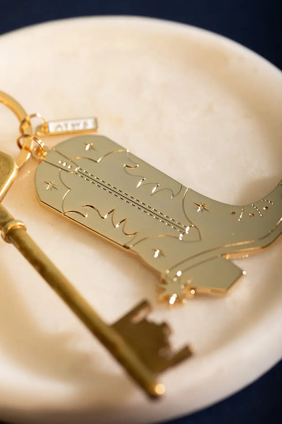 Cowboy Boot Keychain - Close-up on the star engravings and intricate western boot patterns.