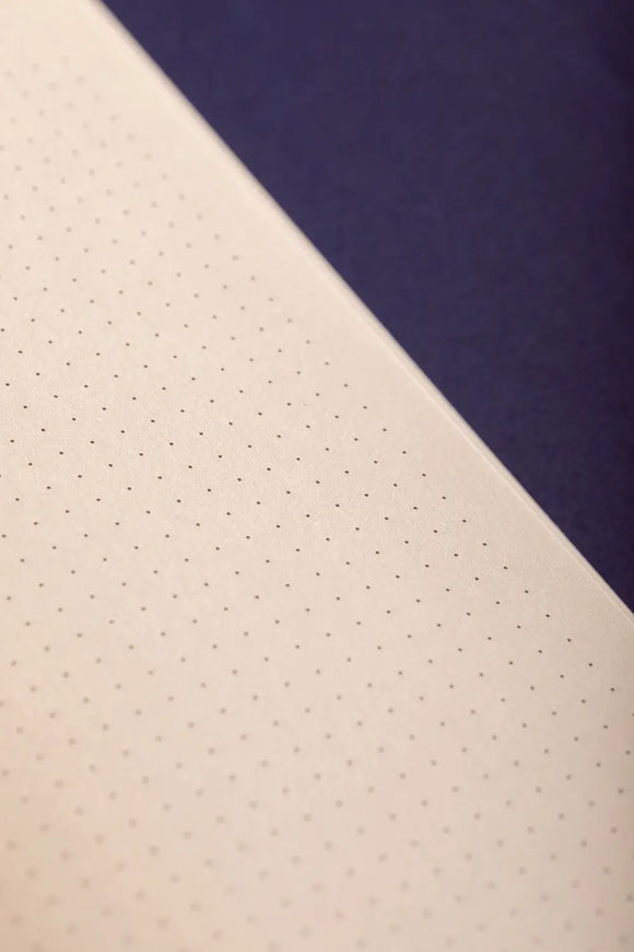 Dog(ue) Notebook A5 - Macro shot of the premium dotted natural paper and binding.