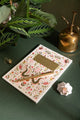 Pink Croco Notebook A5 - Top view displayed with green plants and golden office accessories.