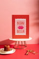 Bisou Bella Hardcover Notebook A5 - Front view on a marble stand with a French cannelé pastry.