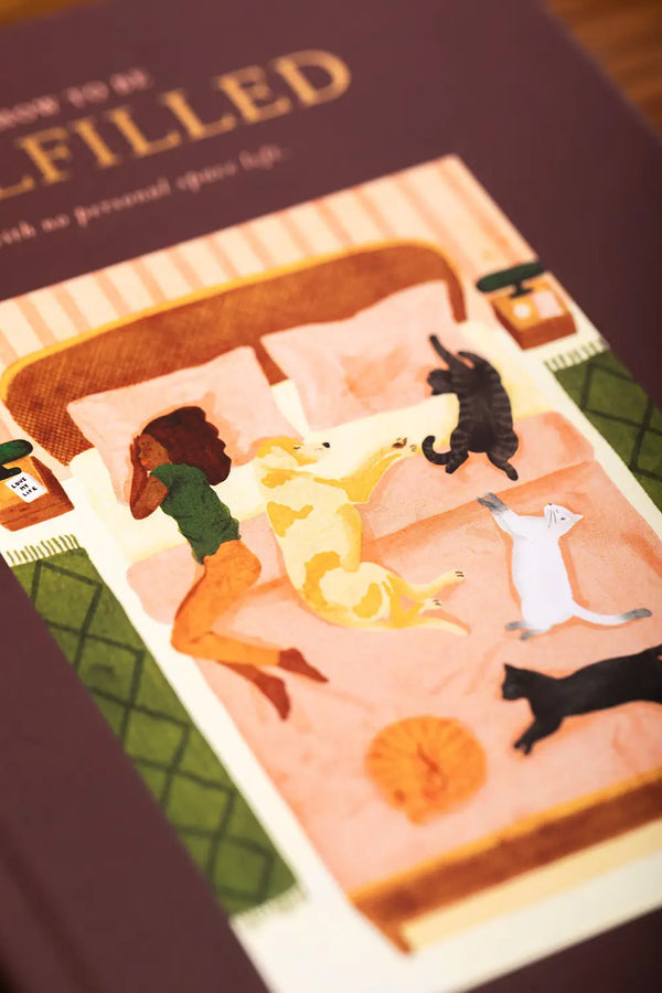 How to be fulfilled Hardcover Notebook A5 - Detailed view of the cozy bed illustration with cats and a dog.