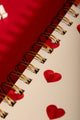 Heart Notebook Spiral - Macro shot of the premium gold double-wire binding and red hearts.