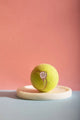 Padel Era - Pins: product photography of the padel era pin on a ball atop a white marble tray.