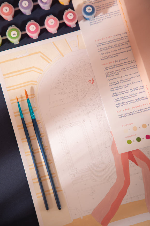 Two paintbrushes on the Parisian Door canvas with the step-by-step instructions and numbered paint pots