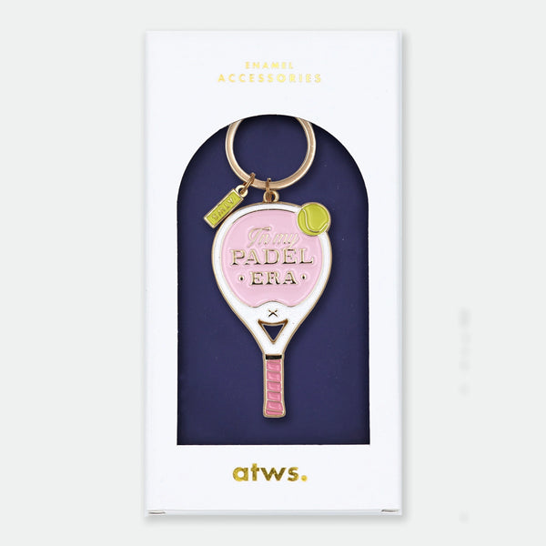 Enamel and metal keychain shaped like a pink and white padel racket with a yellow tennis ball, text reading "In my padel era," gold-tone ring and "ATWS" charm