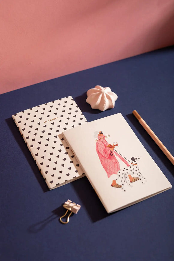 Dalmatian Pocket Notebook A6 DUO - Lifestyle view on a navy desk with a pink pencil.