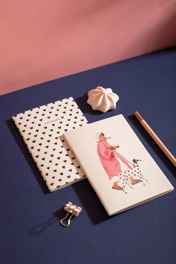 Dalmatian Pocket Notebook A6 DUO - Lifestyle view on a navy desk with a pink pencil.