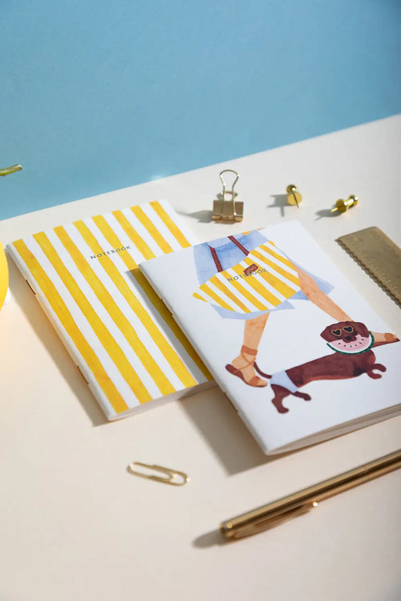 Summer Dachshund Pocket Notebook A6 DUO - Lifestyle view on a white desk with gold accessories.