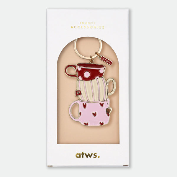 Enamel and metal keychain of three stacked teacups in red polka dot, cream stripe, and pink heart patterns, gold-tone ring and "ATWS" charm