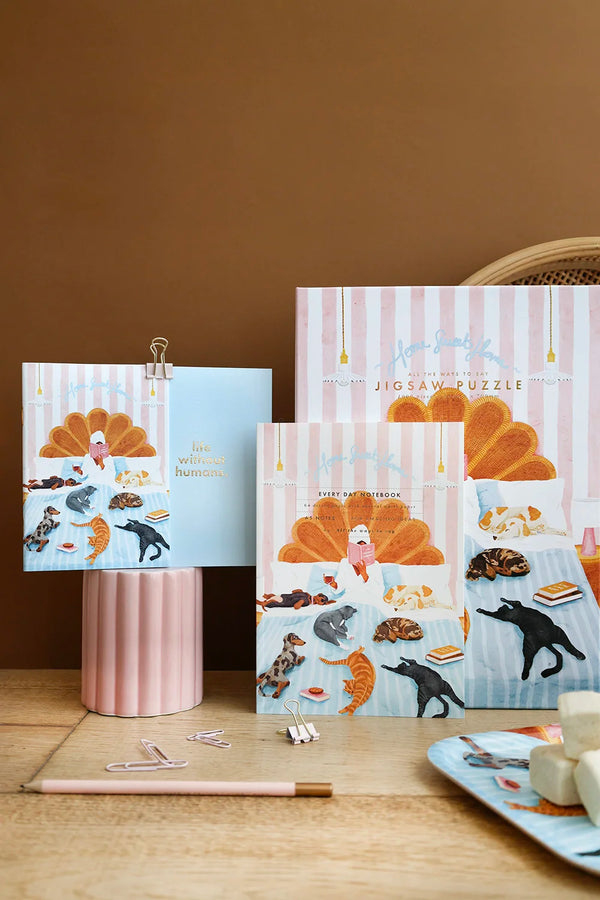Home Sweet Home notebook and puzzle displayed with pastel accessories and illustrated cats and dogs